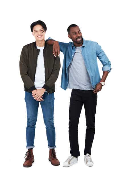 Full length shot of a two young men standing against a white background