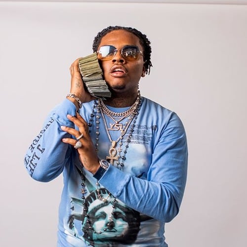 Rapper Gunna Flashy Fit With Money to his ear